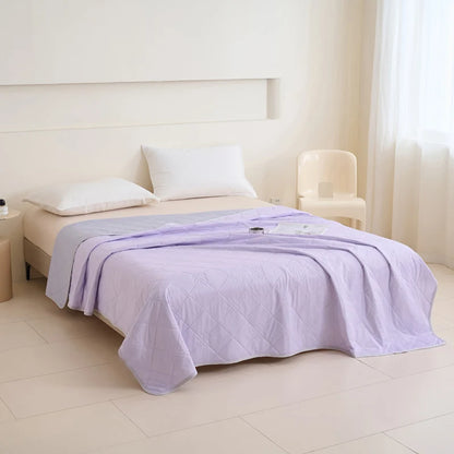 VelmoraMart cooling comforter draped over a bed, showcasing breathable, temperature-regulating fabric for hot sleepers.