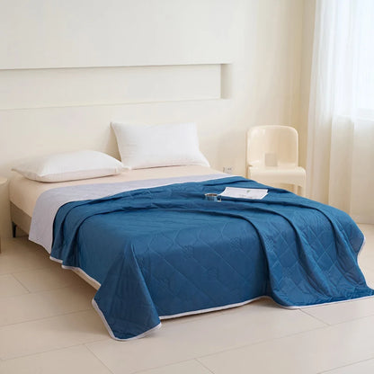 VelmoraMart cooling comforter draped over a bed, showcasing breathable, temperature-regulating fabric for hot sleepers.