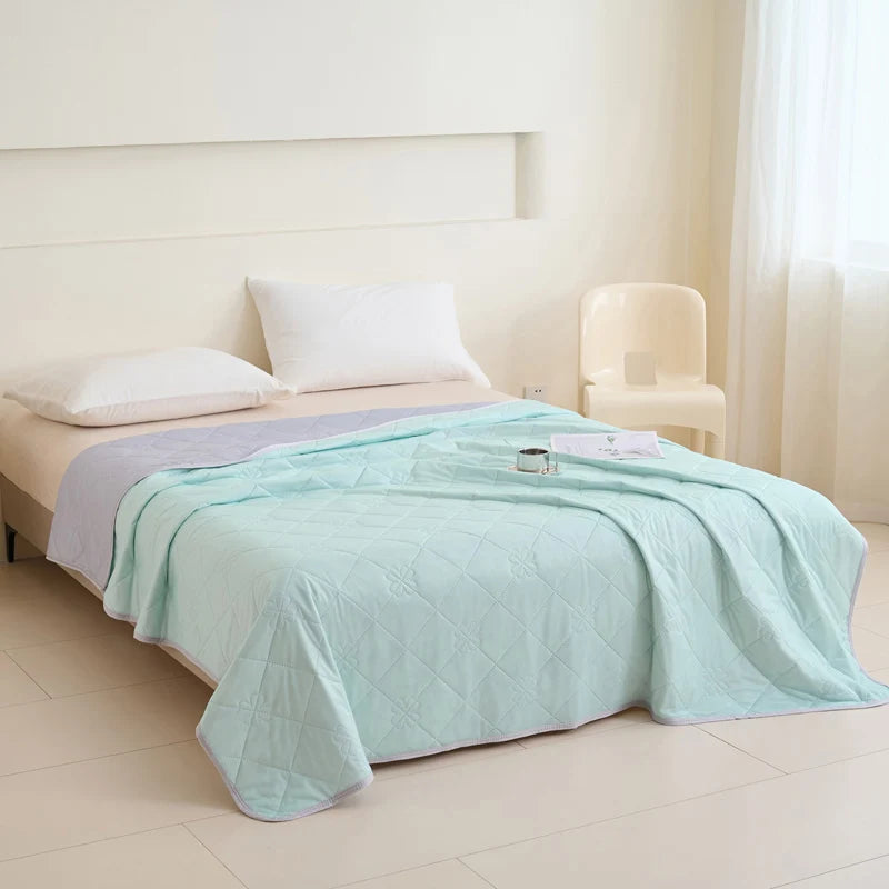 VelmoraMart cooling comforter draped over a bed, showcasing breathable, temperature-regulating fabric for hot sleepers.