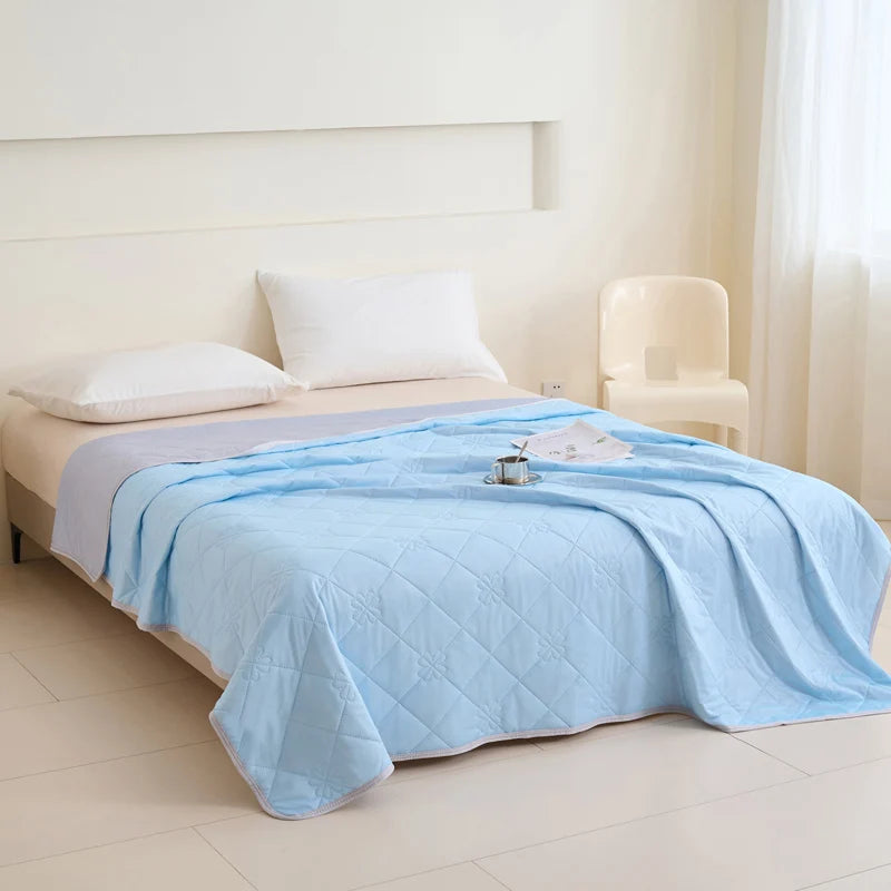 VelmoraMart cooling comforter draped over a bed, showcasing breathable, temperature-regulating fabric for hot sleepers.