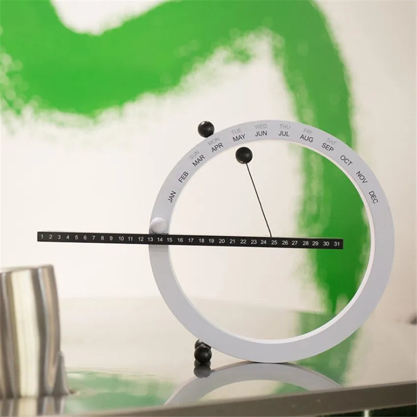 A beautiful wooden perpetual calendar displayed on a clean, minimalist office desk.