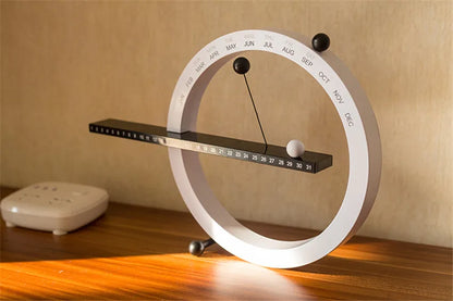 A beautiful wooden perpetual calendar displayed on a clean, minimalist office desk.