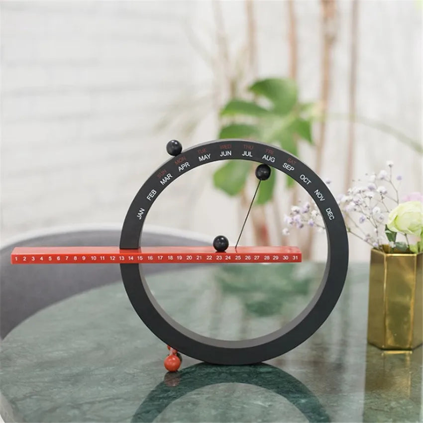 A beautiful wooden perpetual calendar displayed on a clean, minimalist office desk.