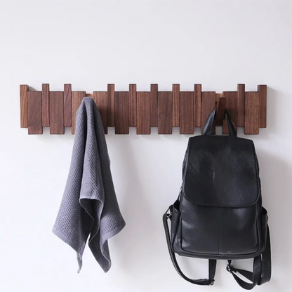 Piano shaped wall mounted wooden coat rack with hidden folding hooks for modern home organization by VelmoraMart.
