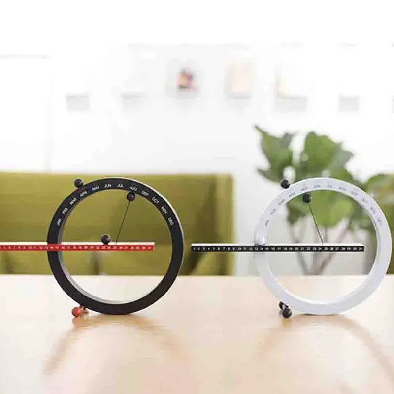 A beautiful wooden perpetual calendar displayed on a clean, minimalist office desk.