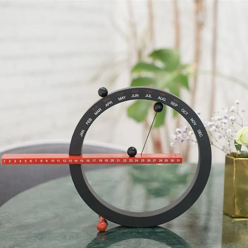 A beautiful wooden perpetual calendar displayed on a clean, minimalist office desk.