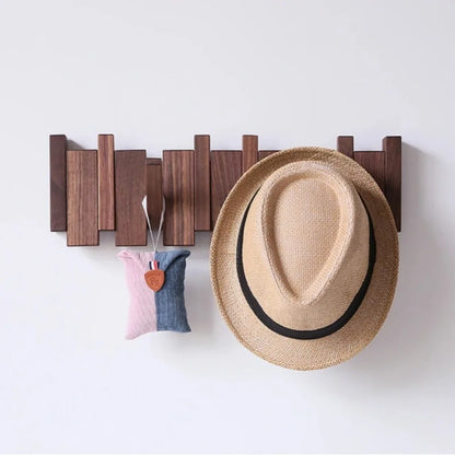 Piano shaped wall mounted wooden coat rack with hidden folding hooks for modern home organization by VelmoraMart.