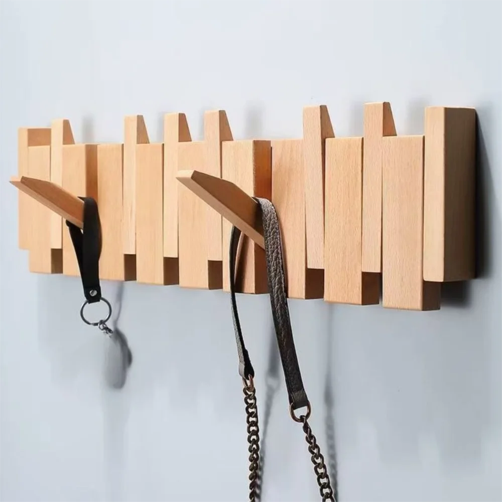 Piano shaped wall mounted wooden coat rack with hidden folding hooks for modern home organization by VelmoraMart.