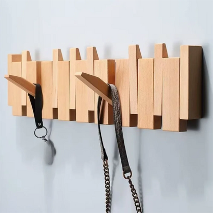 Piano shaped wall mounted wooden coat rack with hidden folding hooks for modern home organization by VelmoraMart.