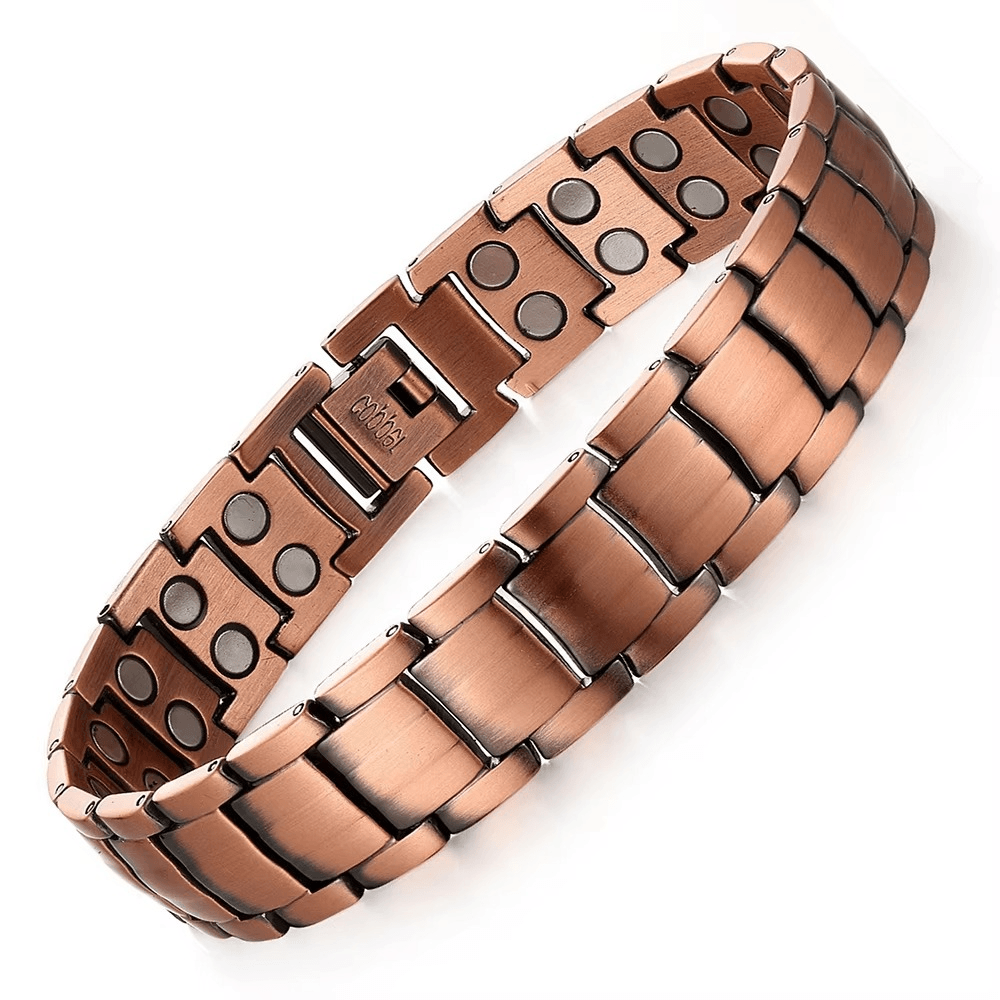 Copper metal bracelet with embedded magnets on a white background