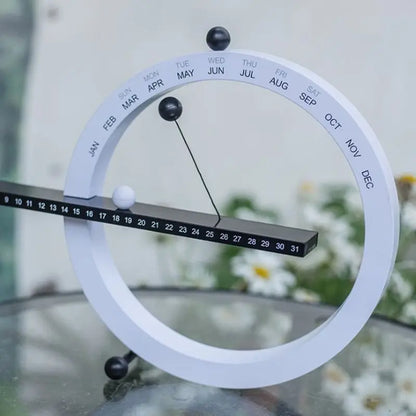 A beautiful wooden perpetual calendar displayed on a clean, minimalist office desk.