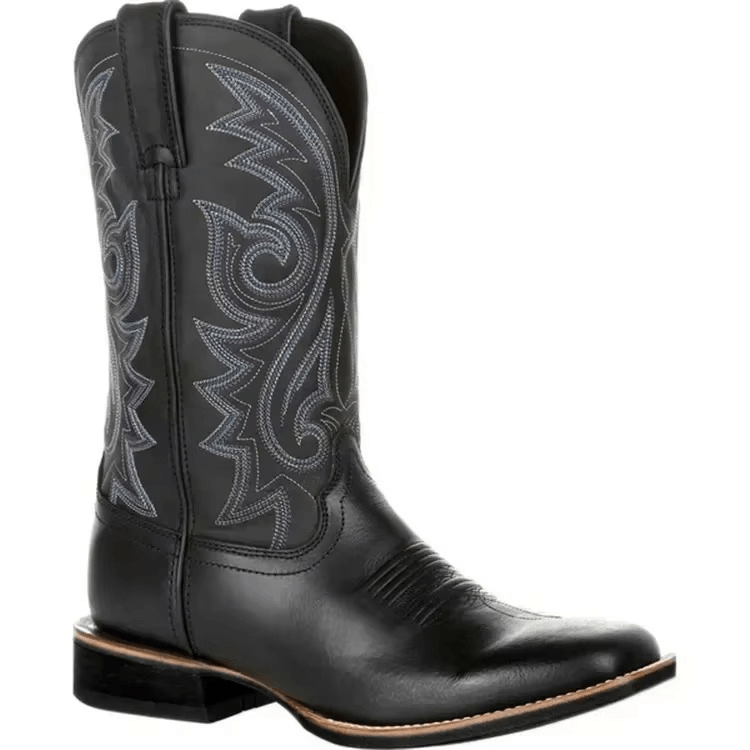 Black cowboy boot with intricate white embroidery on a white background