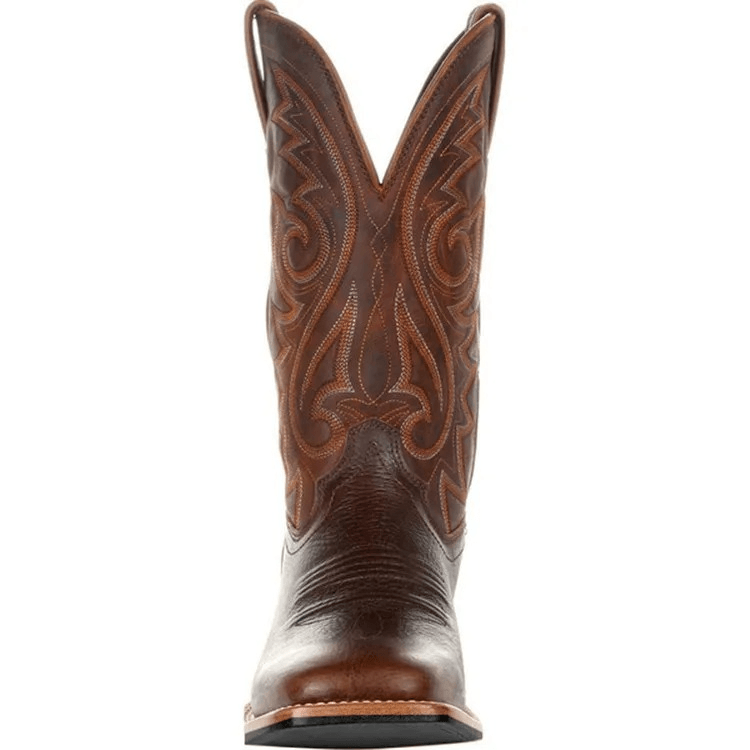 Brown cowboy boot with intricate leatherwork on a white background