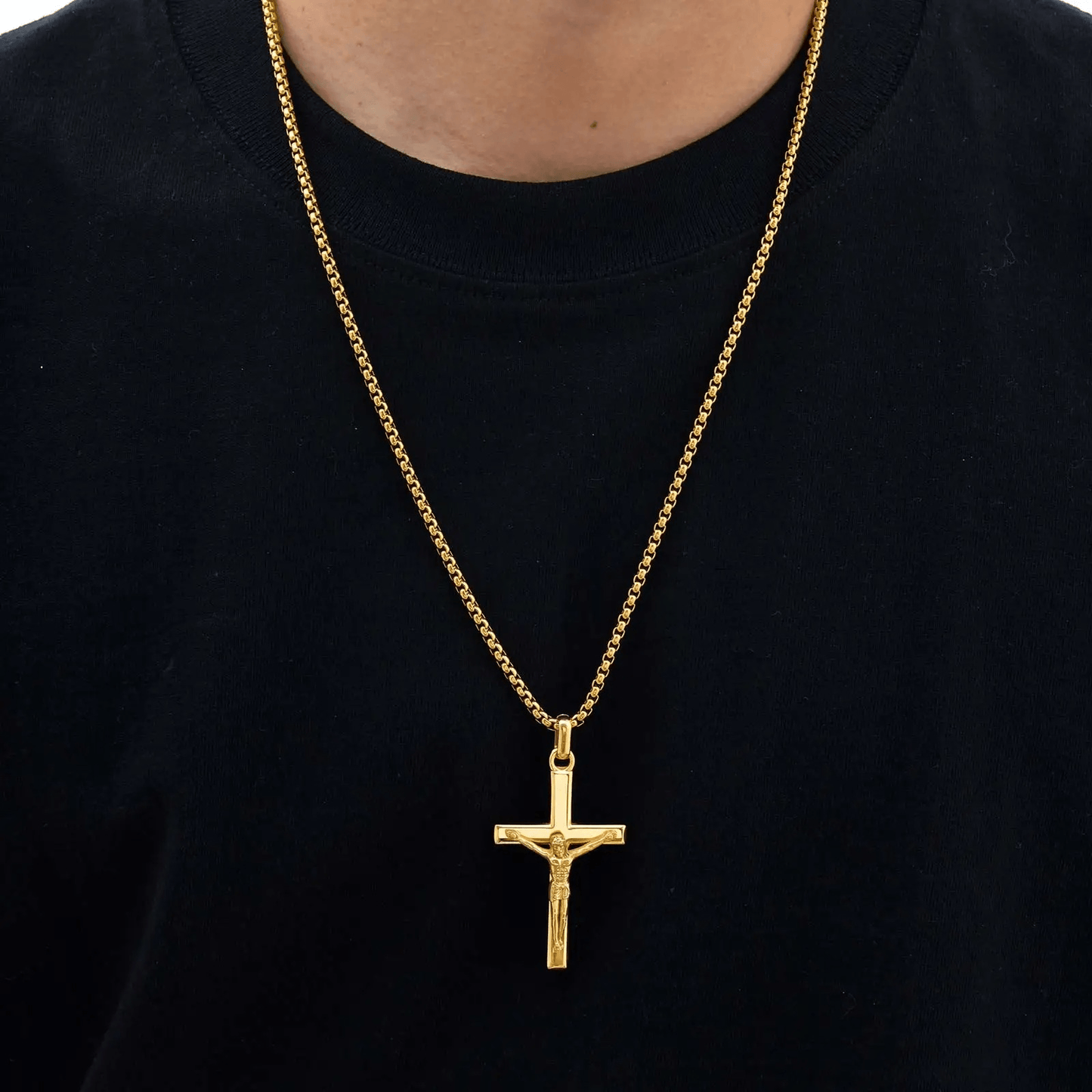 Gold necklace with a cross pendant on a black shirt