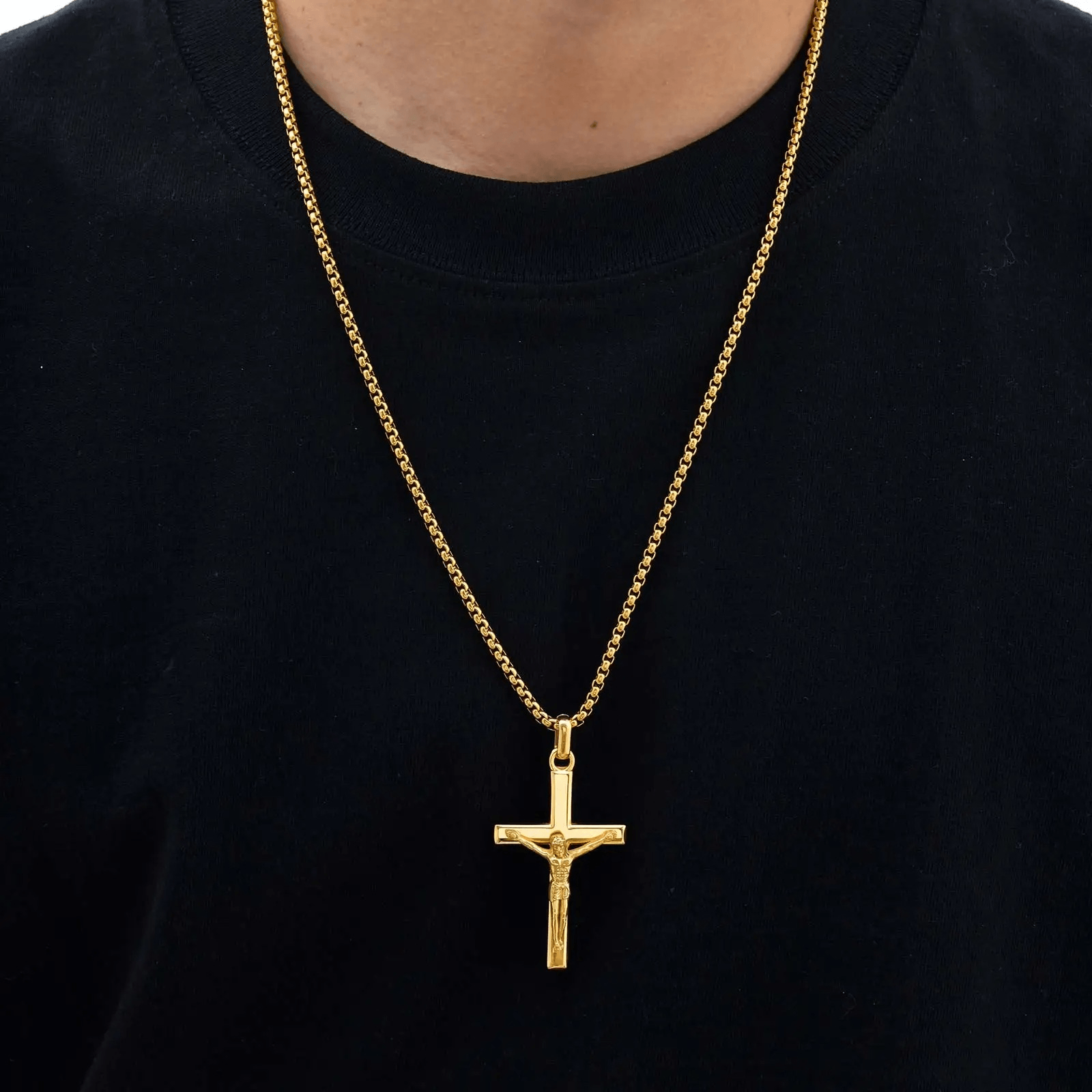 Gold necklace with a cross pendant on a black shirt