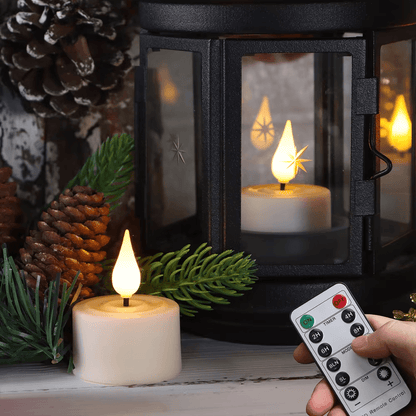 Decorative candle with a lantern and remote control on a table.