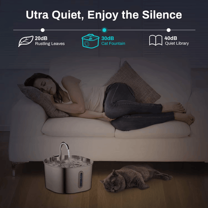 Woman sleeping on a couch with a cat next to a quiet cat fountain, emphasizing its ultra-quiet feature.
