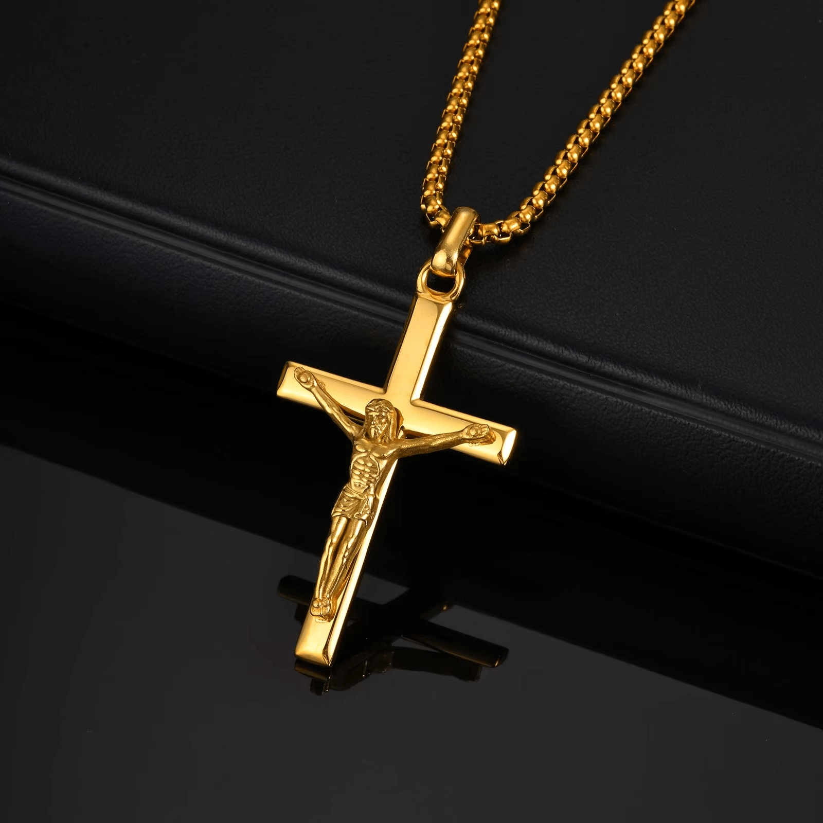 Gold crucifix pendant on a black background