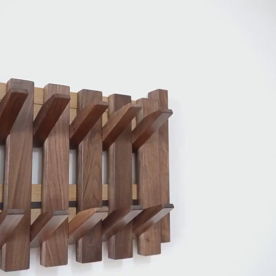 Piano shaped wall mounted wooden coat rack with hidden folding hooks for modern home organization by VelmoraMart.