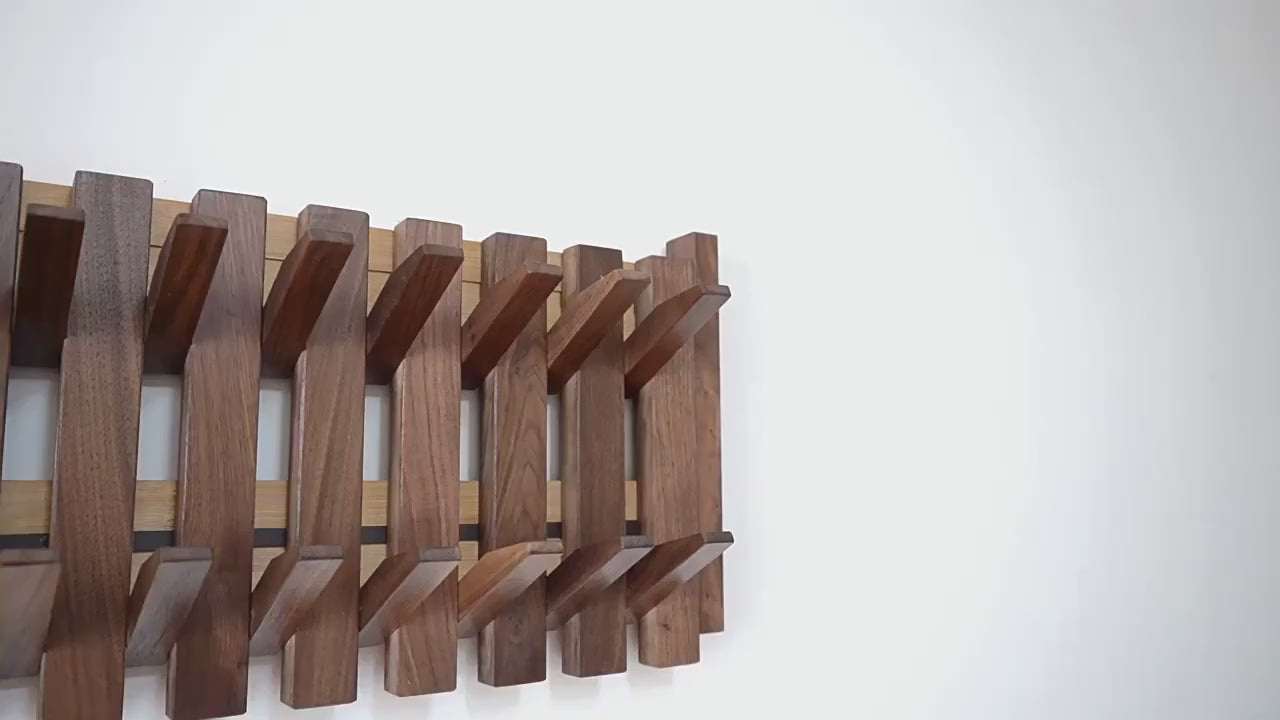 Piano shaped wall mounted wooden coat rack with hidden folding hooks for modern home organization by VelmoraMart.