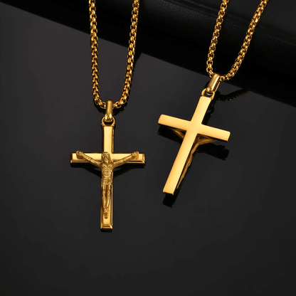 Two gold crucifix pendants on black background